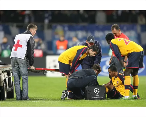 Injured Theo Walcott is treated by Arsenal physio Colin Lewin