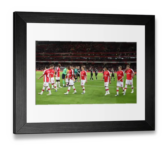Framed Print : The Arsenal team walk out onto the pitch before the match