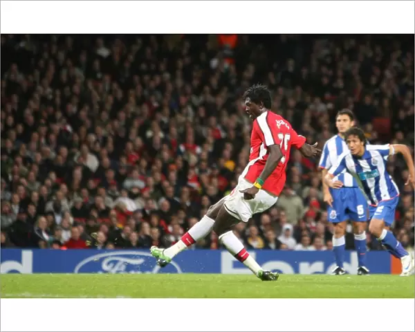 Emmanuel Adebayor shoots past Porto goalkeeper Helton