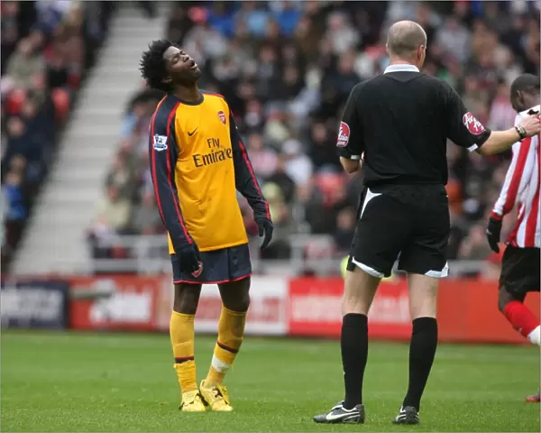 Alex Song (Arsenal) is booked by referee Lee Mason