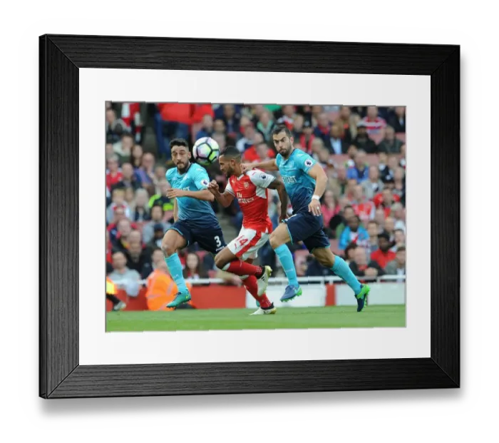 Framed Print : Arsenal's Theo Walcott Battles Swansea Defenders in Intense Clash