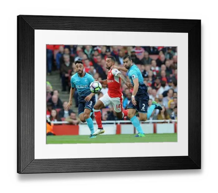 Framed Print : Arsenal's Theo Walcott Faces Off Against Swansea Defenders in Intense Battle
