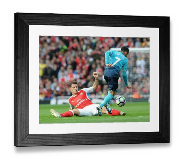 Framed Print : Xhaka vs Britton: Intense Tackle in Arsenal's Victory over Swansea City (2016-17)