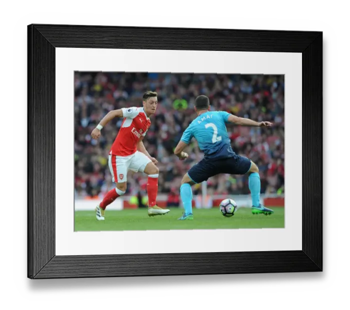 Framed Print : Arsenal's Ozil Slips Past Swansea's Amat in Premier League Showdown Framed Print : Arsenal's Ozil Slips Past Swansea's Amat in Premier League Showdown