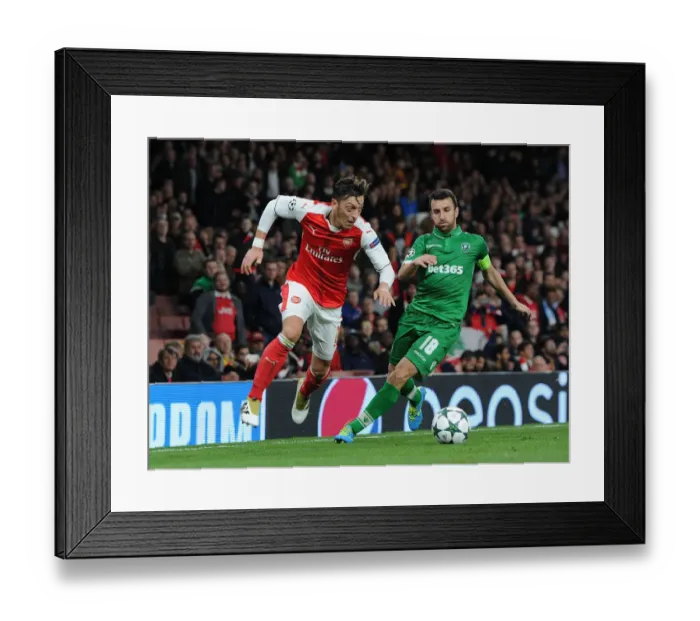 Framed Print : Arsenal vs Ludogorets: Ozil Takes on Dyakov in 2016-17 Champions League Clash