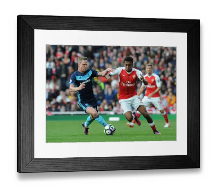Framed Print : Arsenal's Alex Iwobi Clashes with Middlesbrough's Adam Forshaw in Premier League Showdown