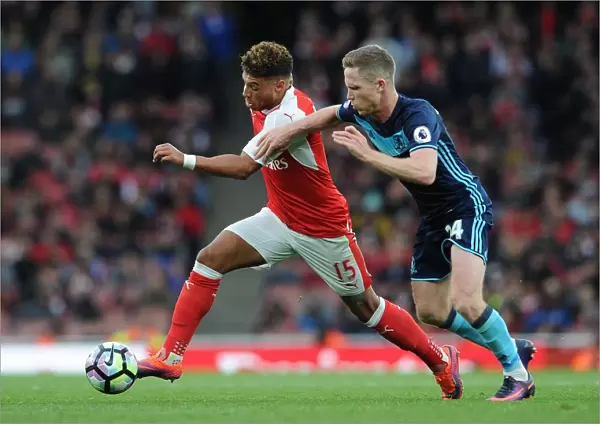 Arsenal's Oxlade-Chamberlain Clashes with Middlesbrough's Forshaw in Premier League Showdown
