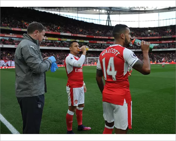 Arsenal Duo Theo Walcott and Alexis Sanchez Prepare for Kick-off Against Middlesbrough (2016-17)