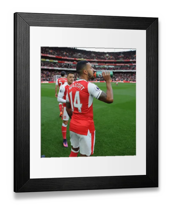 Framed Print : Arsenal Stars Theo Walcott and Alexis Sanchez Hydrate Before Arsenal v Middlesbrough Match, 2016-17
