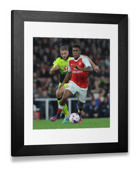 Framed Print : Arsenal's Alex Iwobi Clashes with Reading's Joey van den Berg in EFL Cup Showdown