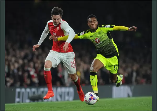 Arsenal's Jenkinson Clashes with Reading's Wieser in EFL Cup Battle