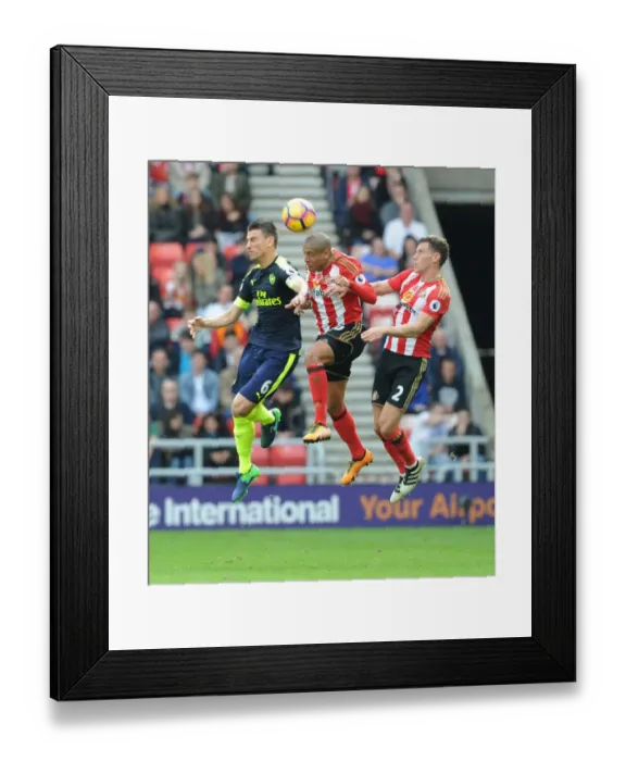 Framed Print : Arsenal's Koscielny Soars Above Sunderland Defenders in Premier League Clash (2016-17)