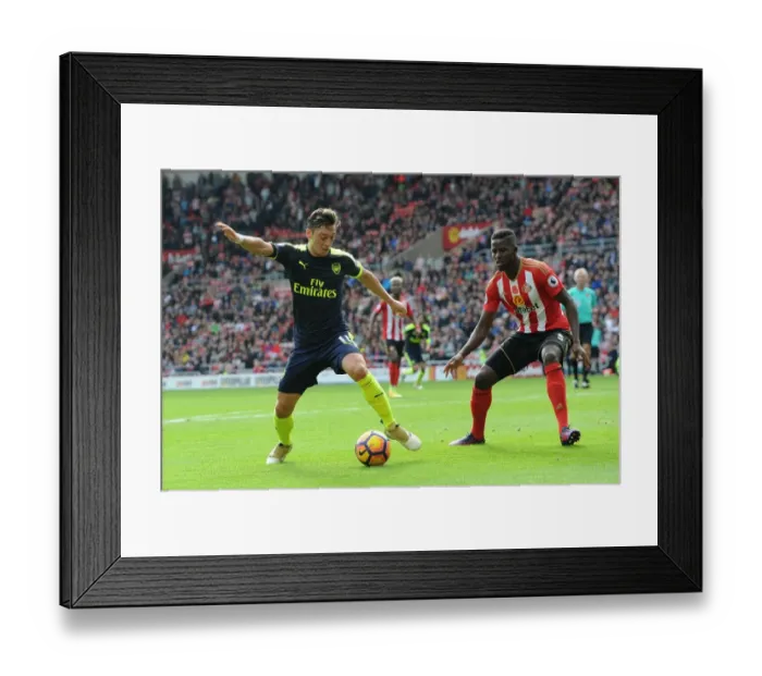 Framed Print : Mesut Ozil Faces Off Against Papy Djilobodji in Intense Sunderland vs. Arsenal Clash