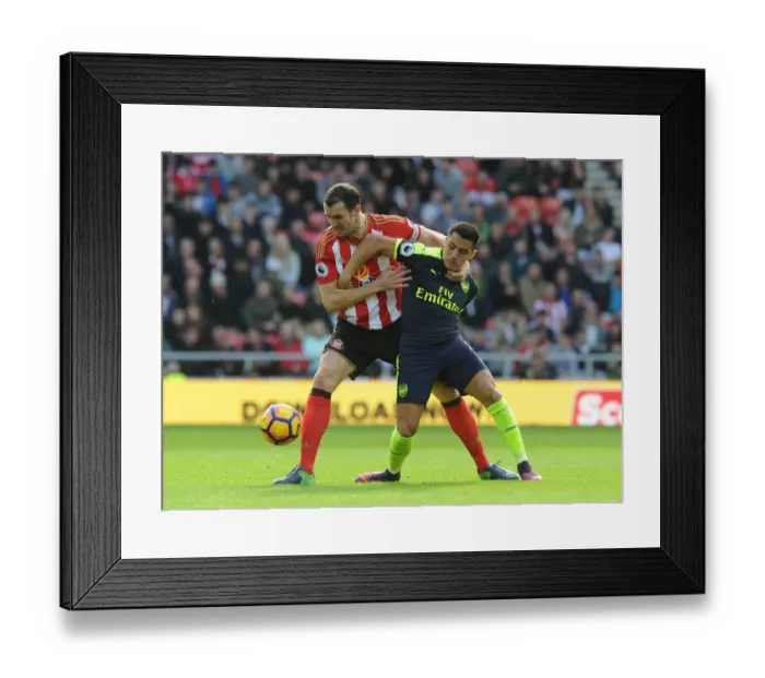 Framed Print : Sanchez vs. O'Shea: Intense Battle in Sunderland v Arsenal (2016-17)
