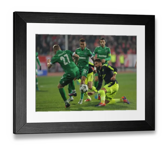 Framed Print : Olivier Giroud vs Cosmin Moti: A Battle in the UEFA Champions League between Arsenal and Ludogorets
