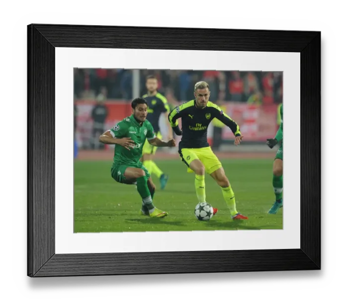 Framed Print : Aaron Ramsey vs. Jose Luis Palomino: Battle in the UEFA Champions League between Arsenal and Ludogorets
