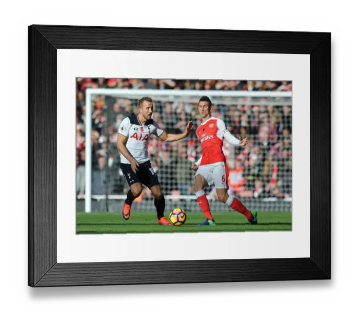 Framed Print : Koscielny vs. Kane: A Premier League Battle at the Emirates