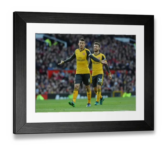 Framed Print : Arsenal's Koscielny and Mustafi Face Off Against Manchester United