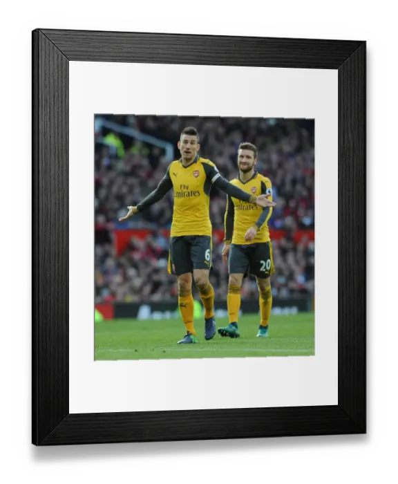 Framed Print : Arsenal Rivals Koscielny and Mustafi Clash in Intense Manchester United Showdown Framed Print : Arsenal Rivals Koscielny and Mustafi Clash in Intense Manchester United Showdown
