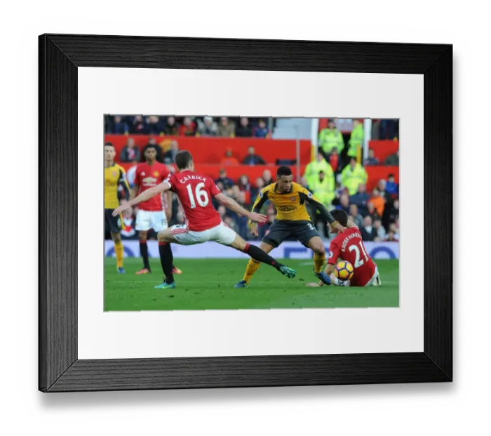 Framed Print : Clash of Titans: Coquelin Stands Firm Against Manchester United's Midfield Duo Framed Print : Clash of Titans: Coquelin Stands Firm Against Manchester United's Midfield Duo