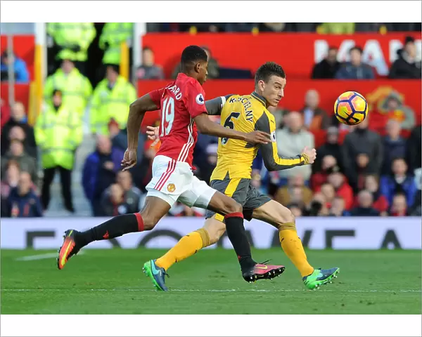 Arsenal's Koscielny Faces Pressure from Rashford in Manchester United Clash (Premier League 2016-17)