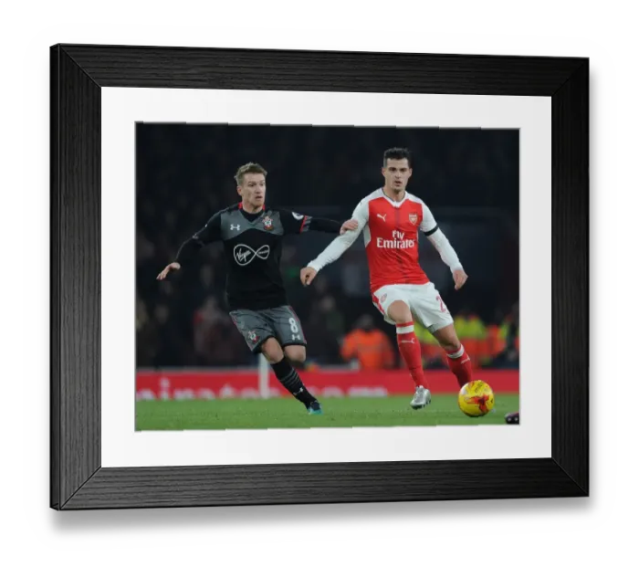 Framed Print : Arsenal's Granit Xhaka Overpowers Southampton's Steven Davis in EFL Cup Quarter-Final Showdown