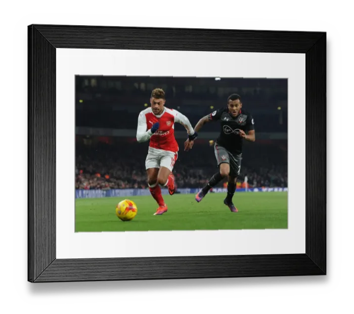 Framed Print : Arsenal's Oxlade-Chamberlain Clashes with Southampton's Bertrand in EFL Cup Quarter-Final