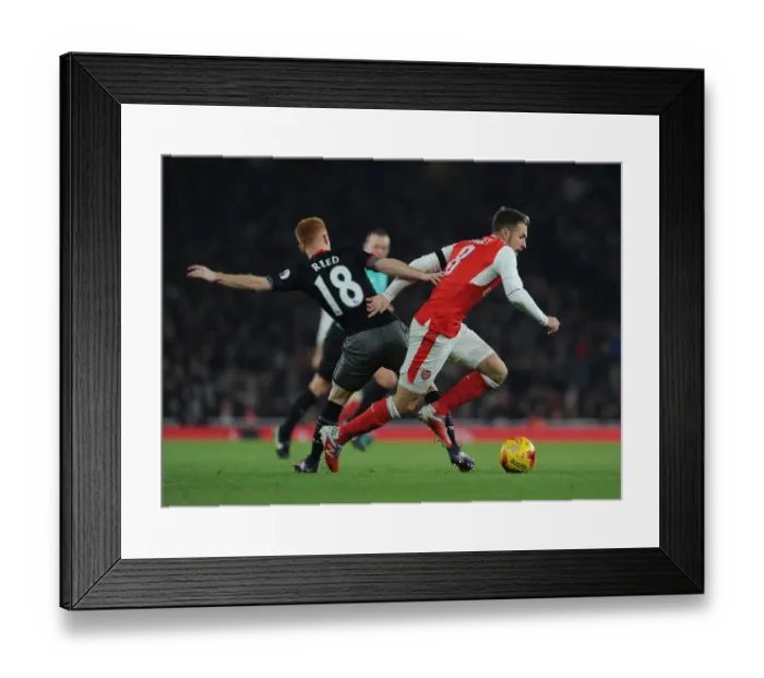 Framed Print : Arsenal's Aaron Ramsey Faces Off Against Southampton's Harrison Reed in EFL Cup Clash