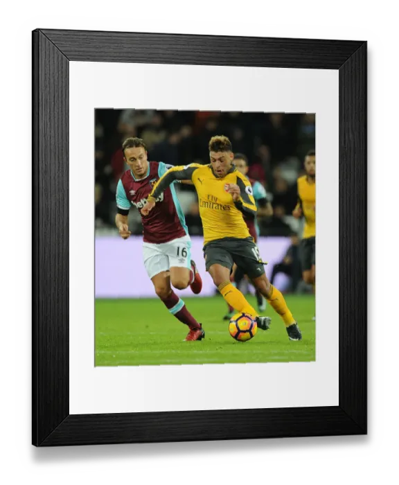 Framed Print : Arsenal's Oxlade-Chamberlain Outmaneuvers West Ham's Noble in Premier League Clash