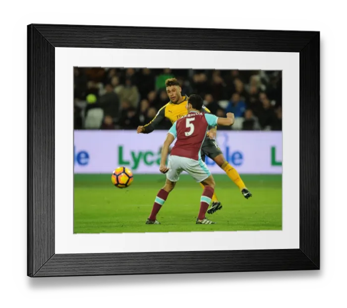 Framed Print : Arsenal's Oxlade-Chamberlain Faces Off Against West Ham's Arbeloa in Premier League Clash