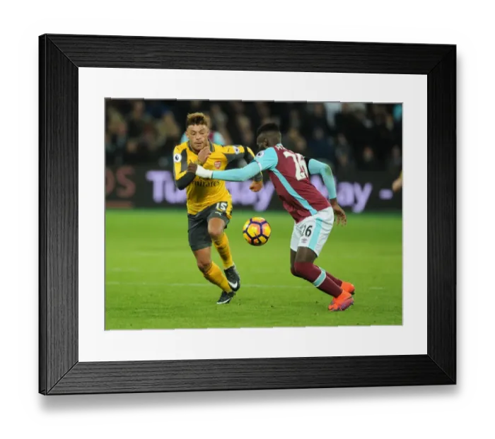 Framed Print : Arsenal's Oxlade-Chamberlain Clashes with West Ham's Masuaku in Premier League Showdown Framed Print : Arsenal's Oxlade-Chamberlain Clashes with West Ham's Masuaku in Premier League Showdown