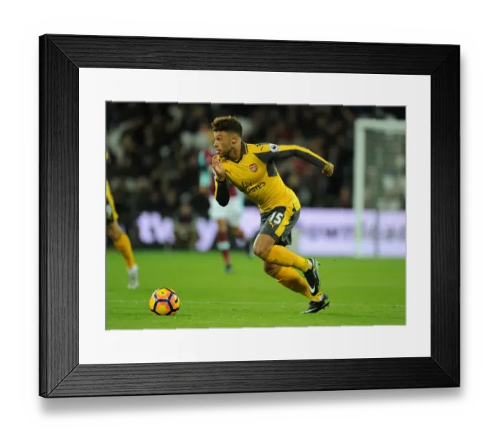 Framed Print : Arsenal's Oxlade-Chamberlain Faces Off Against West Ham in Premier League Battle Framed Print : Arsenal's Oxlade-Chamberlain Faces Off Against West Ham in Premier League Battle