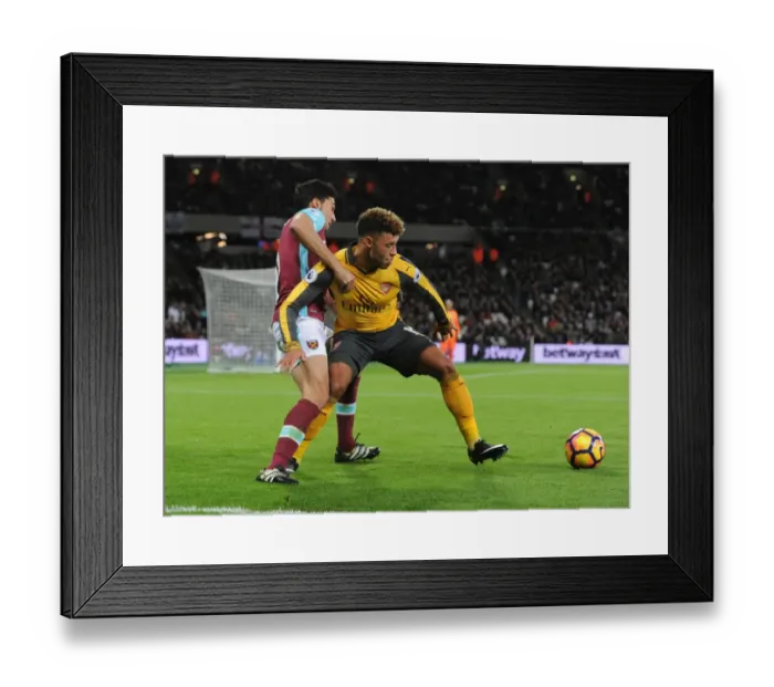 Framed Print : Arsenal's Oxlade-Chamberlain Fends Off West Ham's Arbeloa in Premier League Clash Framed Print : Arsenal's Oxlade-Chamberlain Fends Off West Ham's Arbeloa in Premier League Clash