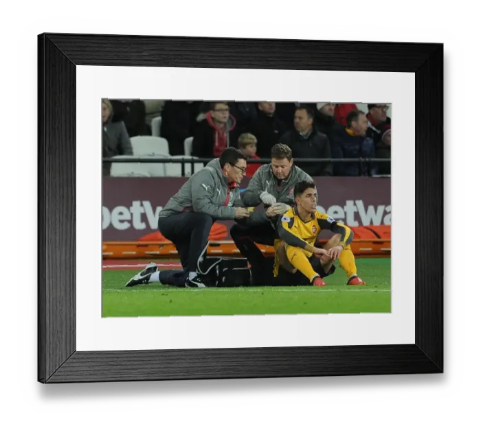 Framed Print : Arsenal's Gabriel Receives Treatment from Medical Team During West Ham Match Framed Print : Arsenal's Gabriel Receives Treatment from Medical Team During West Ham Match