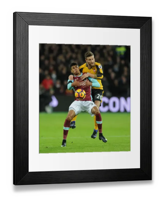 Framed Print : Mustafi vs Fletcher: Intense Clash in West Ham United vs Arsenal Premier League Match