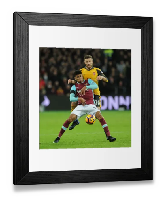 Framed Print : Mustafi vs Fletcher: Intense Battle in West Ham United vs Arsenal Premier League Clash