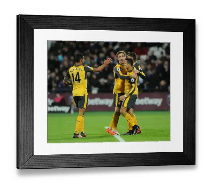 Framed Print : Mesut Ozil, Alexis Sanchez, Theo Walcott, and Nacho Monreal Celebrate Arsenal's First Goal Against West Ham United
