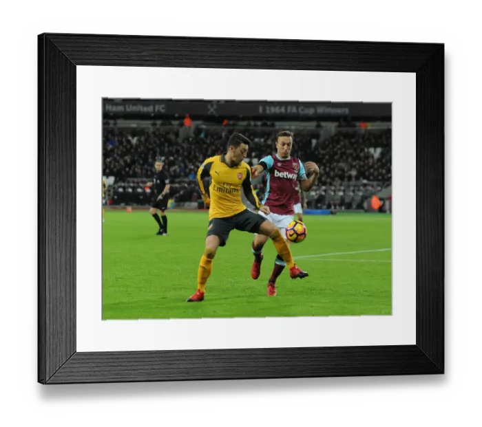Framed Print : Mesut Ozil vs Mark Noble: Intense Battle in West Ham United vs Arsenal Premier League Clash Framed Print : Mesut Ozil vs Mark Noble: Intense Battle in West Ham United vs Arsenal Premier League Clash