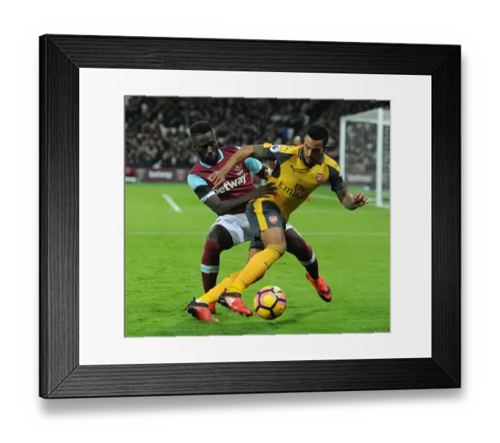 Framed Print : Walcott vs. Masuaku: A Football Rivalry Erupts in the West Ham United vs. Arsenal Clash