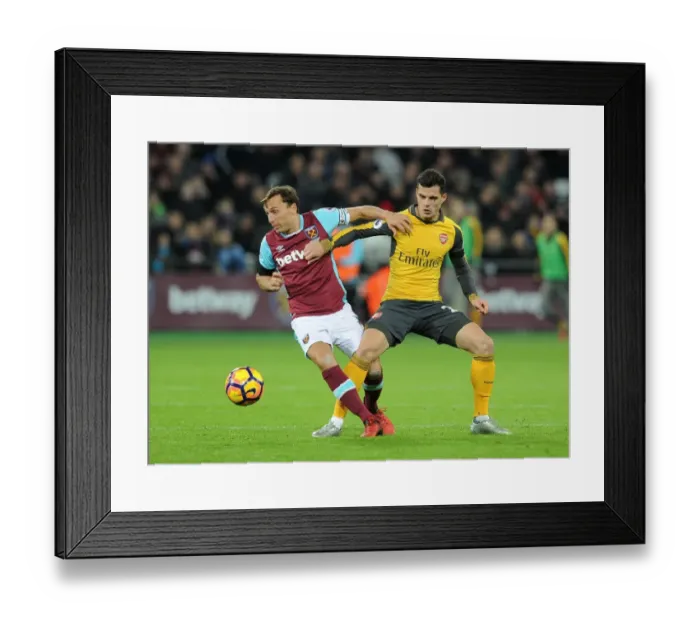 Framed Print : Xhaka vs. Noble: Intense Battle in West Ham United vs. Arsenal Premier League Clash Framed Print : Xhaka vs. Noble: Intense Battle in West Ham United vs. Arsenal Premier League Clash