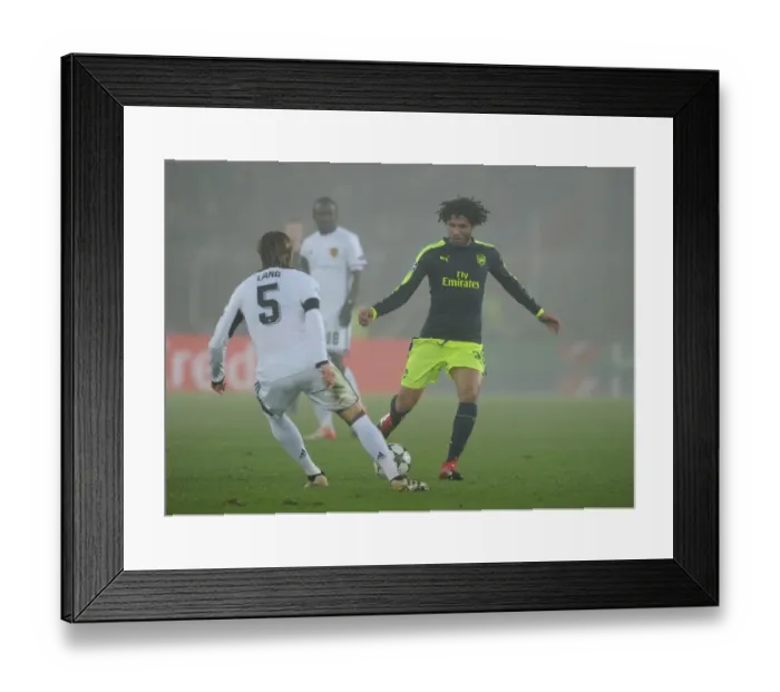 Framed Print : Mohamed Elneny vs Michael Lang: Intense Clash Between FC Basel and Arsenal in the 2016-17 UEFA Champions League Framed Print : Mohamed Elneny vs Michael Lang: Intense Clash Between FC Basel and Arsenal in the 2016-17 UEFA Champions League