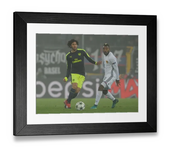 Framed Print : Mohamed Elneny Breaks Past Basel's Geoffroy Serey Die: Arsenal's UEFA Champions League Clash vs FC Basel (December 2016)