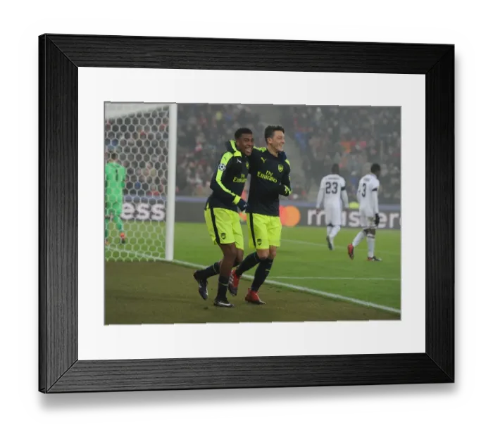 Framed Print : Arsenal's Ozil and Iwobi Celebrate Goals Against FC Basel in 2016-17 UEFA Champions League
