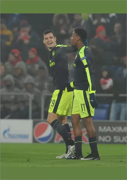 Arsenal's Alex Iwobi and Granit Xhaka Celebrate Goals Against FC Basel in 2016-17 UEFA Champions League