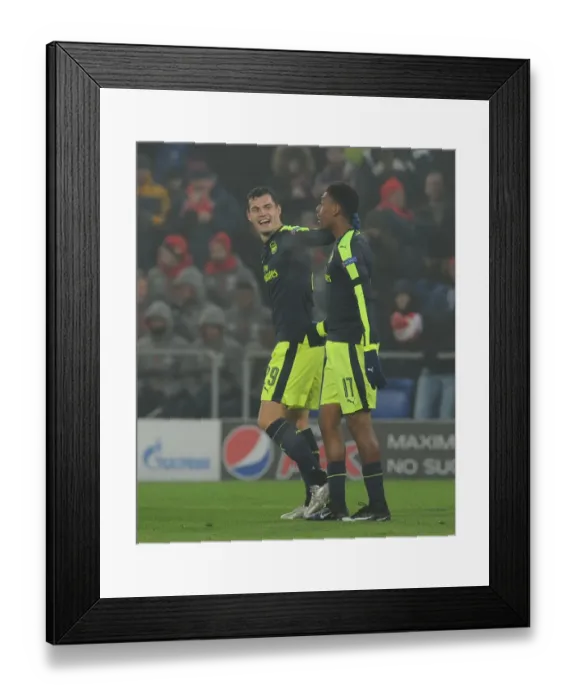 Framed Print : Arsenal's Alex Iwobi and Granit Xhaka Celebrate Goals Against FC Basel in 2016-17 UEFA Champions League