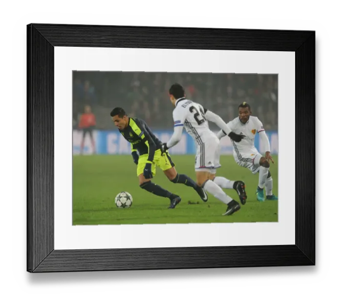 Framed Print : Arsenal's Alexis Sanchez Faces Off Against Basel's Mohamed Elyounoussi and Geoffroy Serey in 2016-17 UEFA Champions League Clash