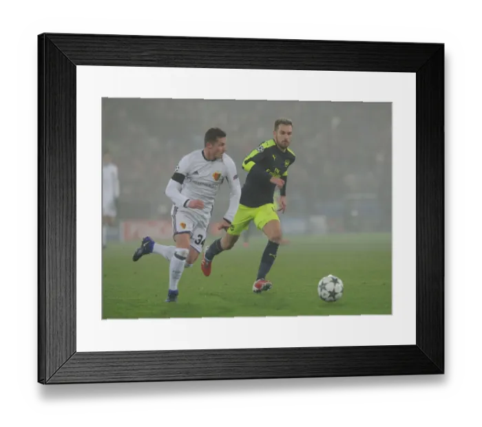 Framed Print : Arsenal's Aaron Ramsey Clashes with Basel's Taulant Xhaka in UEFA Champions League Match Framed Print : Arsenal's Aaron Ramsey Clashes with Basel's Taulant Xhaka in UEFA Champions League Match
