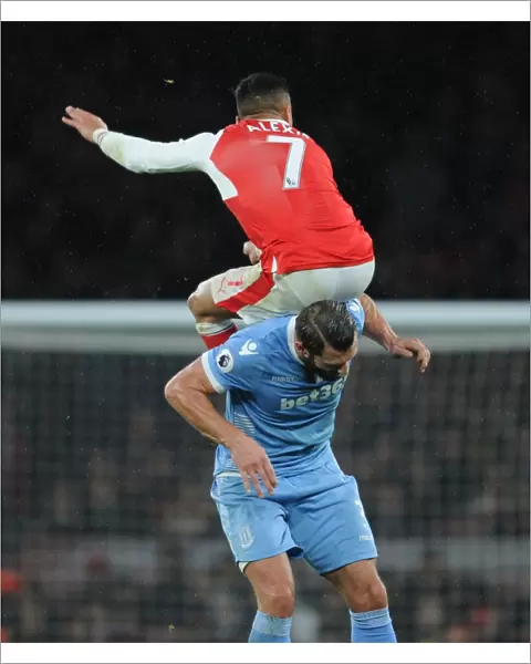 Arsenal's Alexis Sanchez Leaps Above Stoke's Erik Pieters in Premier League Clash