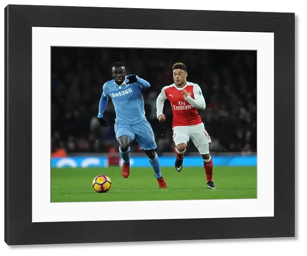 Fierce Rivalry: Oxlade-Chamberlain vs. Diouf Clash at Arsenal v Stoke City (2016-17)