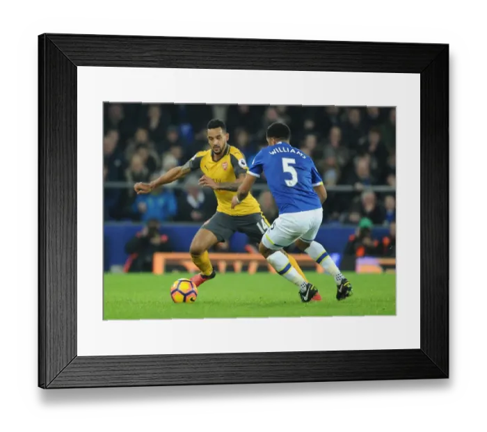 Framed Print : Theo Walcott vs. Ashley Williams: A Premier League Showdown at Goodison Park